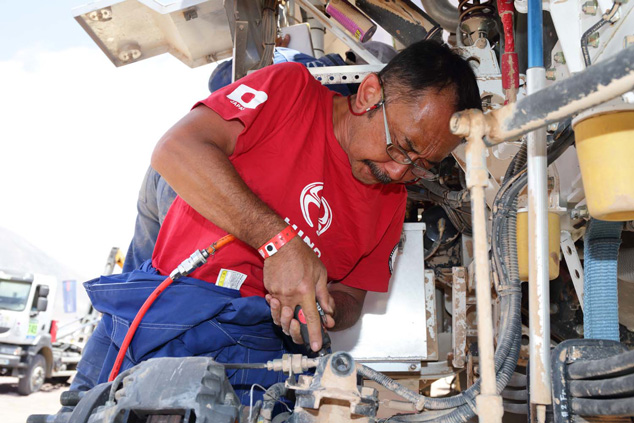 Mechanic leader Seiichi Suzuki adjusts a shock absorber mount.