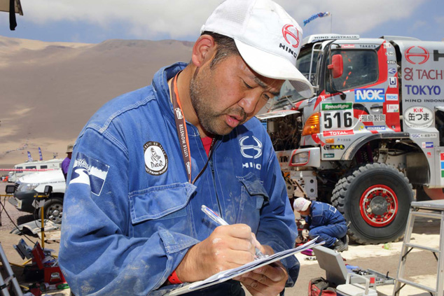 Mechanic sub-leader Takeshi Suenaga goes over the servicing checklist.