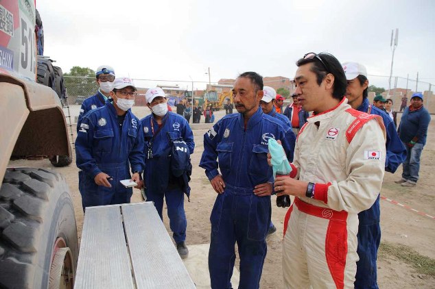 Teruhito Sugawara goes over servicing procedures with mechanics.