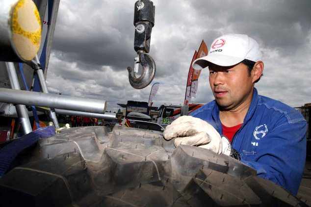 Mechanic, Masaki Tagoku gets a new tire ready.