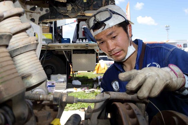Mechanic, Masato Kondo inspects the front caliper.