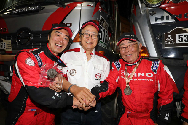 Mr. Ichikawa, Hino Motors chairman with father and son duo, Yoshimasa and Teruhito Sugawara.