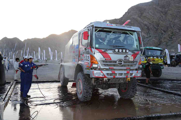 Mechanics wash down Car 1.