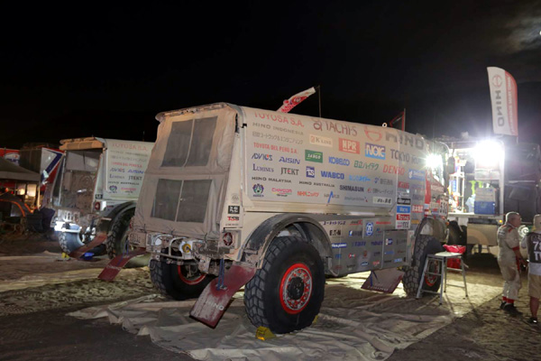 Parked side by side, the HINO500 Series trucks are being serviced by team mechanics.