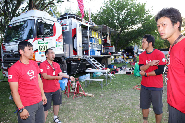 Team mechanics are preparing for the trucks' arrival.