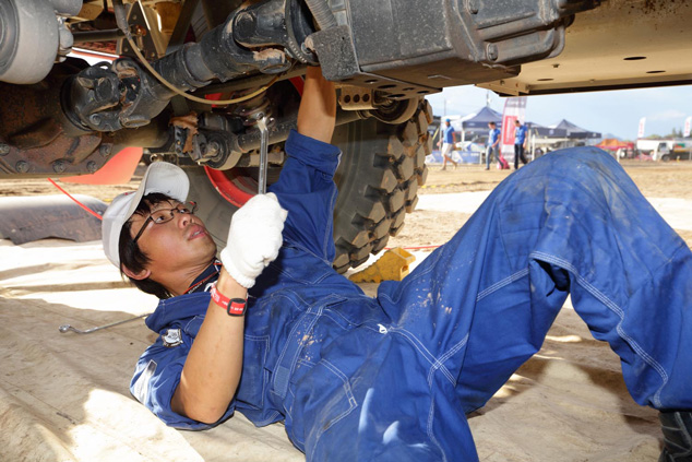 Mechanic Takashi Masuda inspects the drive train for loose components.