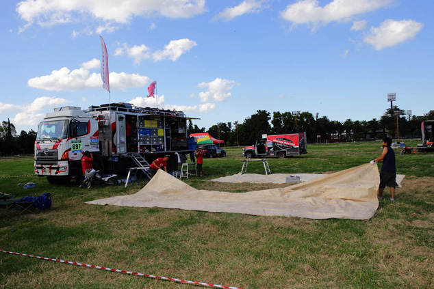 The Hino team prepares for their servicing work at the bivouac set up in a horse racing track.