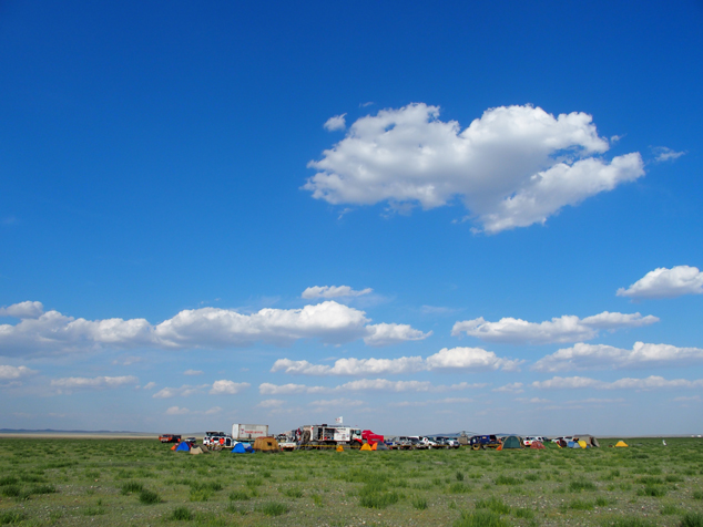 The team's camp was set up on a grassy plain.