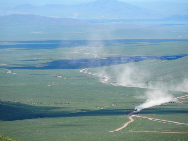 HINO500 Series truck racing through vast grassland.