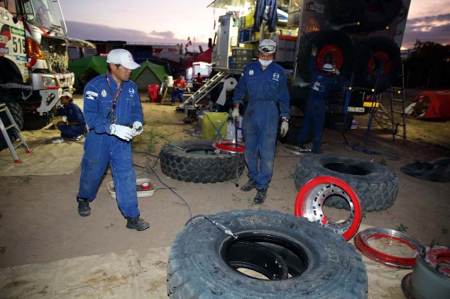 Mechanics replace the wheels that blew their tires.