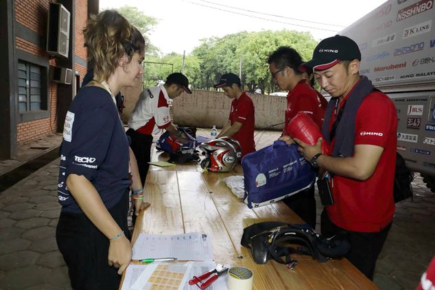 Team staff is busy checking the trucks' safety equipment.